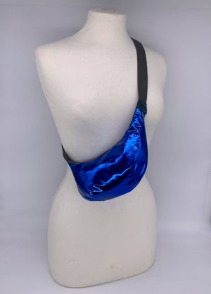 Small crossbody bag in electric blue leather worn across a mannequin